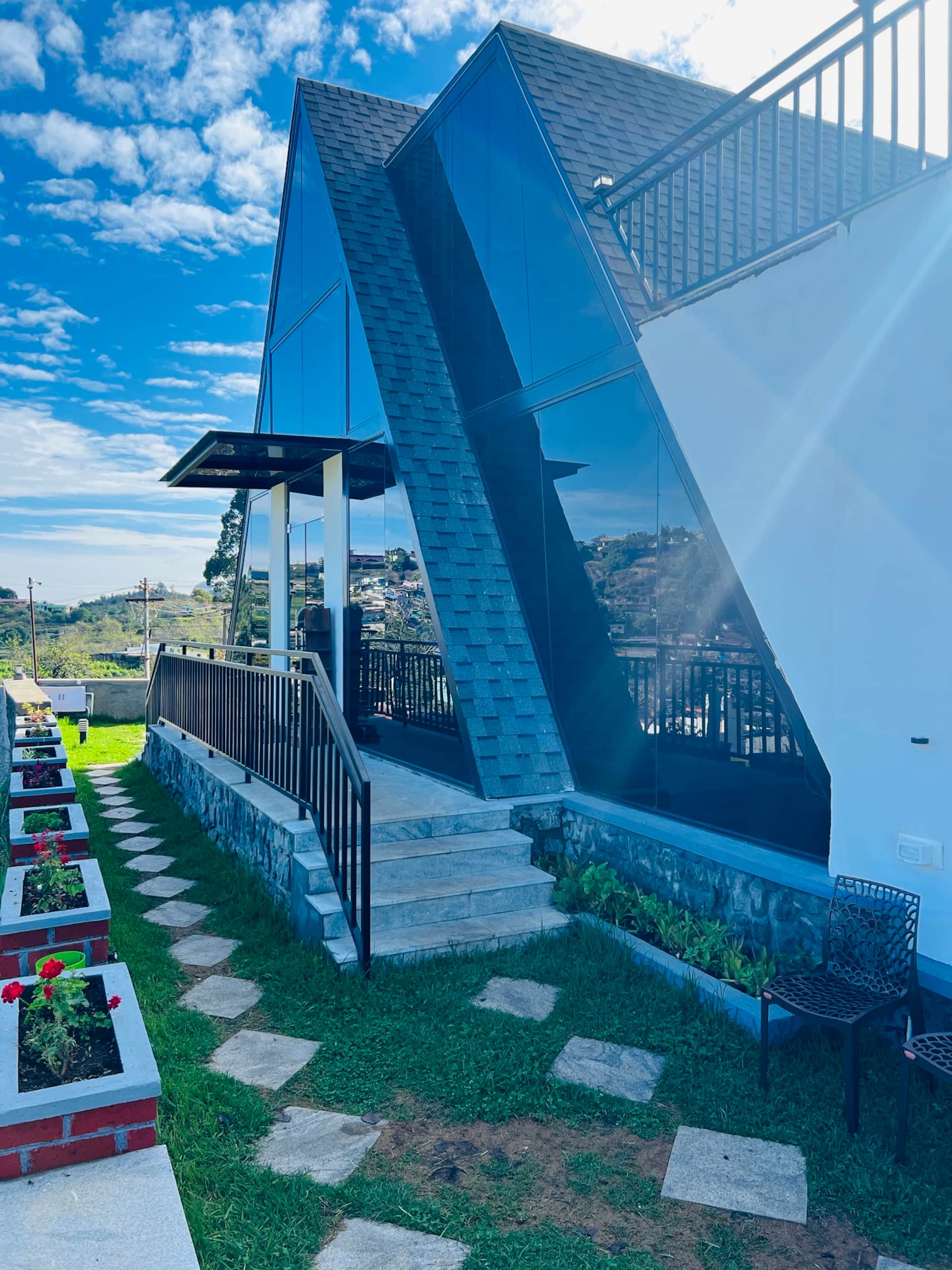 Glass A-frame facade against blue sky